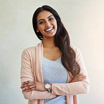 Studio portrait of an attractive and happy young woman crossing her arms confidently